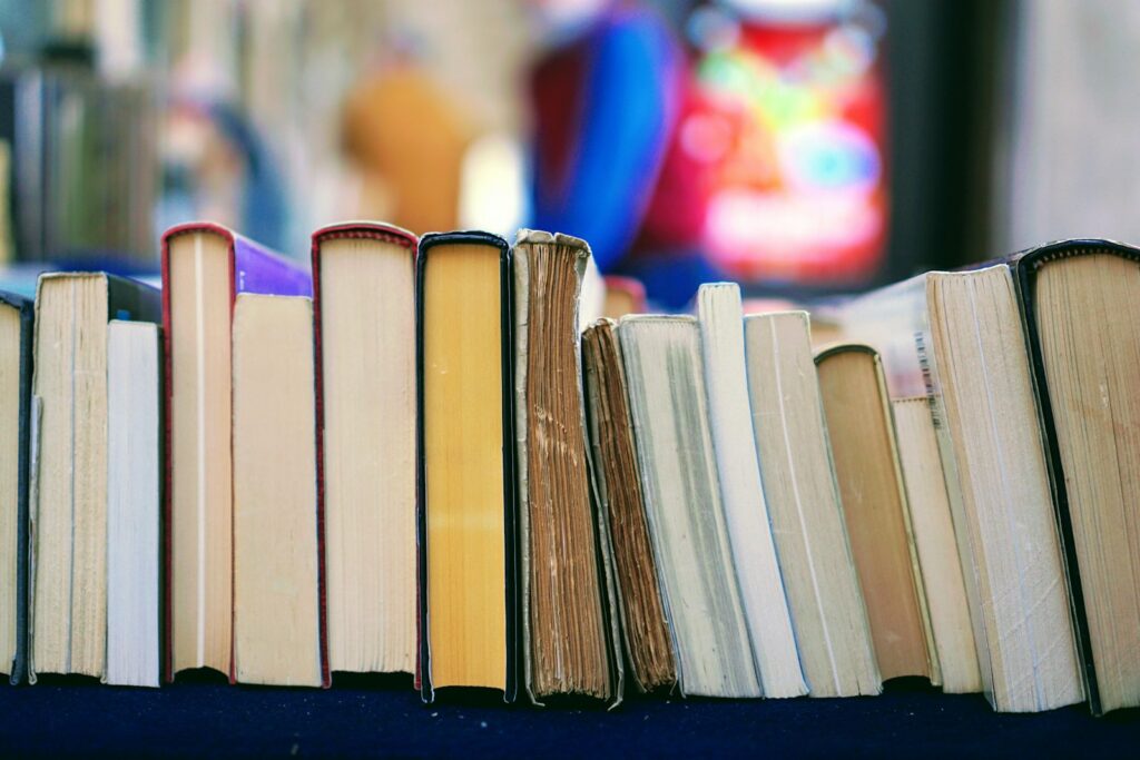 Open philosophy books representing Spinoza’s ideas